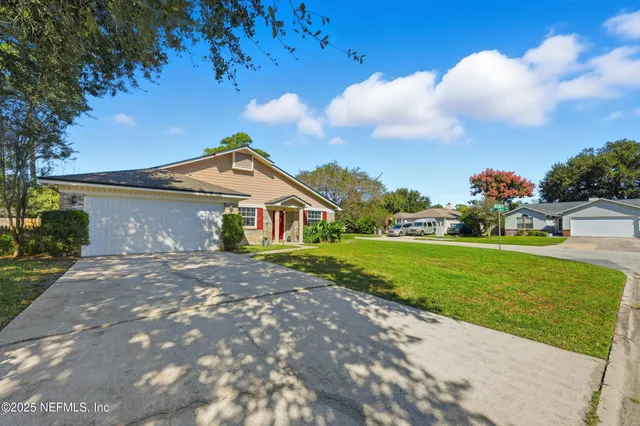 a view of backyard of house with green space