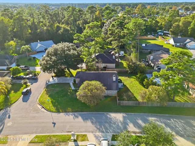 a aerial view of a house with a yard swimming pool and outdoor seating