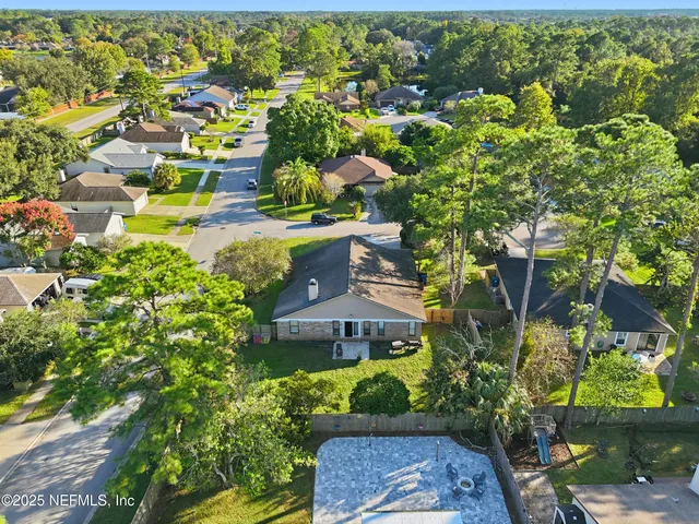 an aerial view of a house with a yard