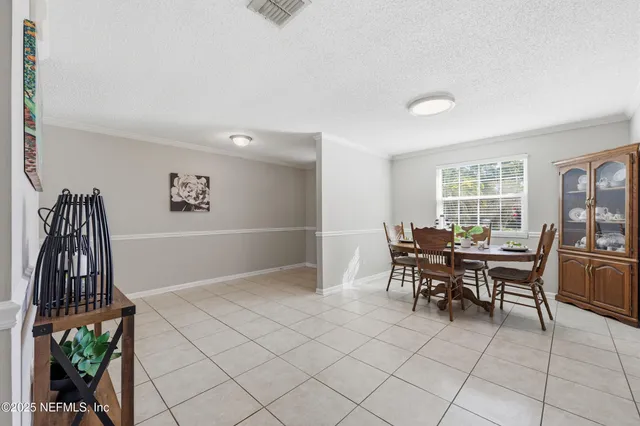 a view of a dining room and livingroom with furniture wooden floor and a rug