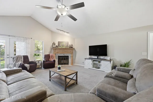 a living room with furniture a flat screen tv and a fireplace
