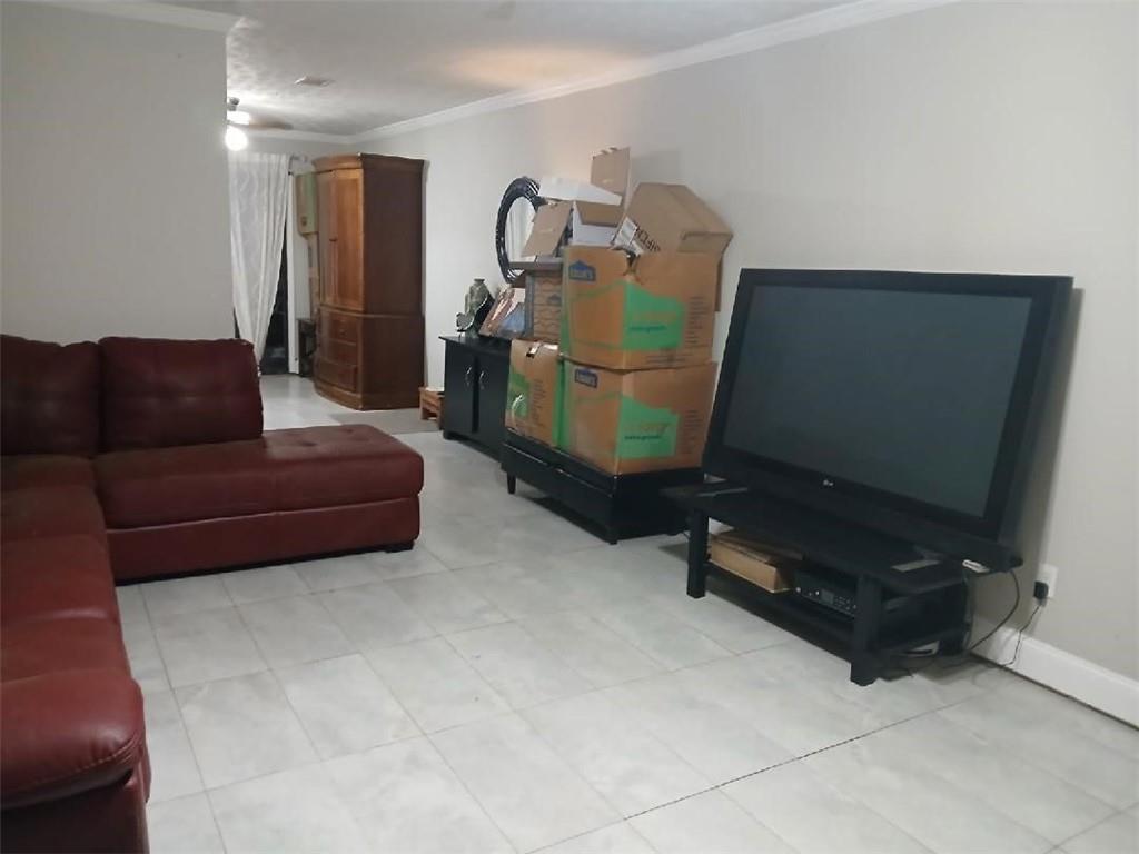 2340 Beaver Ruin Road, Unit UN41 Norcross, GA 30071 - Photo 4 of 12 a living room with furniture and a flat screen tv