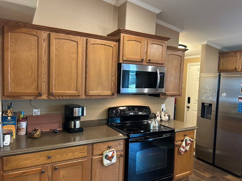 162 Cove View Drive Trinity, TX 75862 - Photo 12 of 50 a kitchen with stainless steel appliances granite countertop a refrigerator a stove a sink and dishwasher