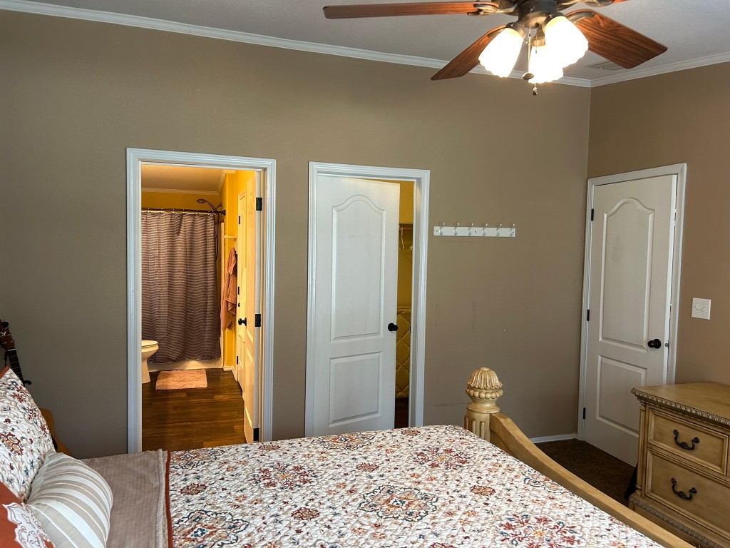 162 Cove View Drive Trinity, TX 75862 - Photo 16 of 50 a bedroom with a bed and a chandelier
