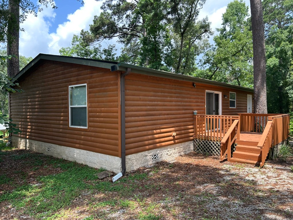 162 Cove View Drive Trinity, TX 75862 - Photo 48 of 50 a view of a house with a yard chairs and wooden fence