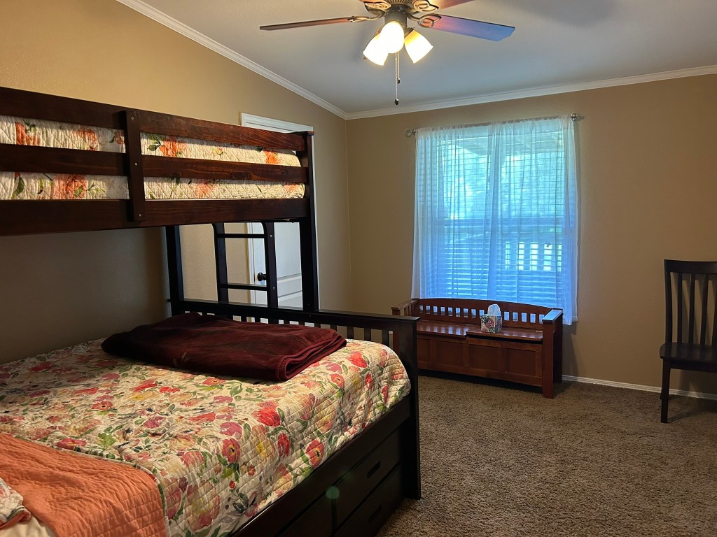 162 Cove View Drive Trinity, TX 75862 - Photo 26 of 50 a bedroom with a bed and a chandelier