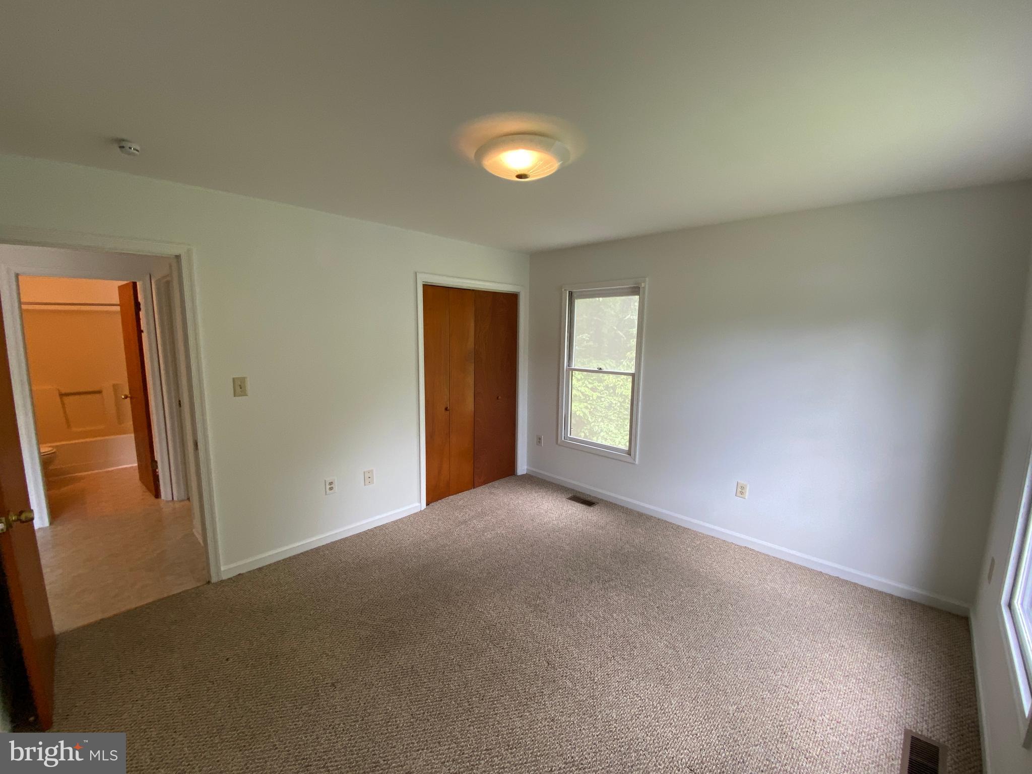 9298 Hayden Drive, Unit 14 King George, VA 22485 - Photo 14 of 17 an empty room with windows and closet