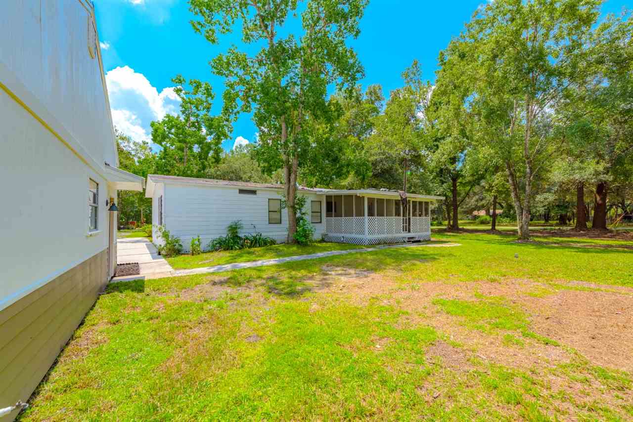 2360 Marlee Road South St. Johns, FL 32259 - Photo 11 of 22 a backyard of a house with swimming pool and large trees