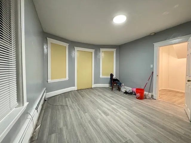 a view of room with wooden floor and windows