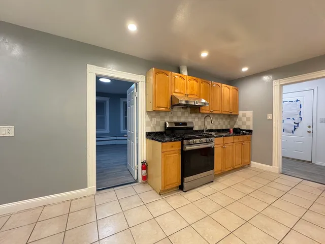 a kitchen with stainless steel appliances a refrigerator sink and cabinets
