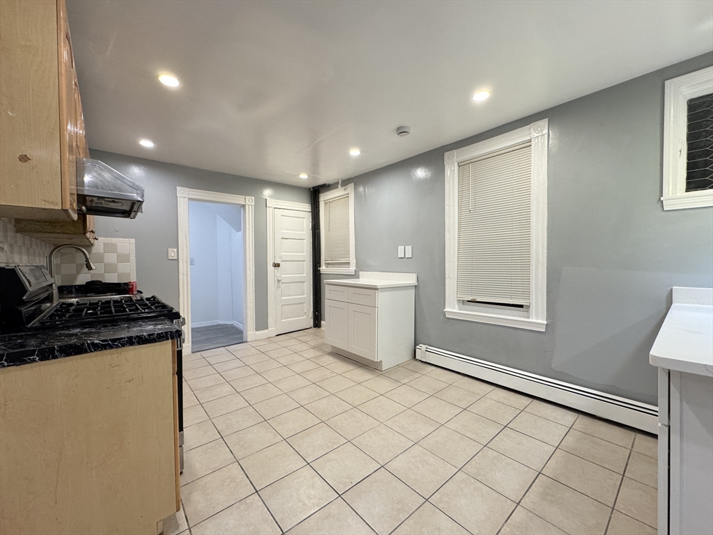 10 Faxon Road, Unit 1 Quincy, MA 02171 - Photo 3 of 11 a kitchen with stainless steel appliances granite countertop a stove a sink and a refrigerator