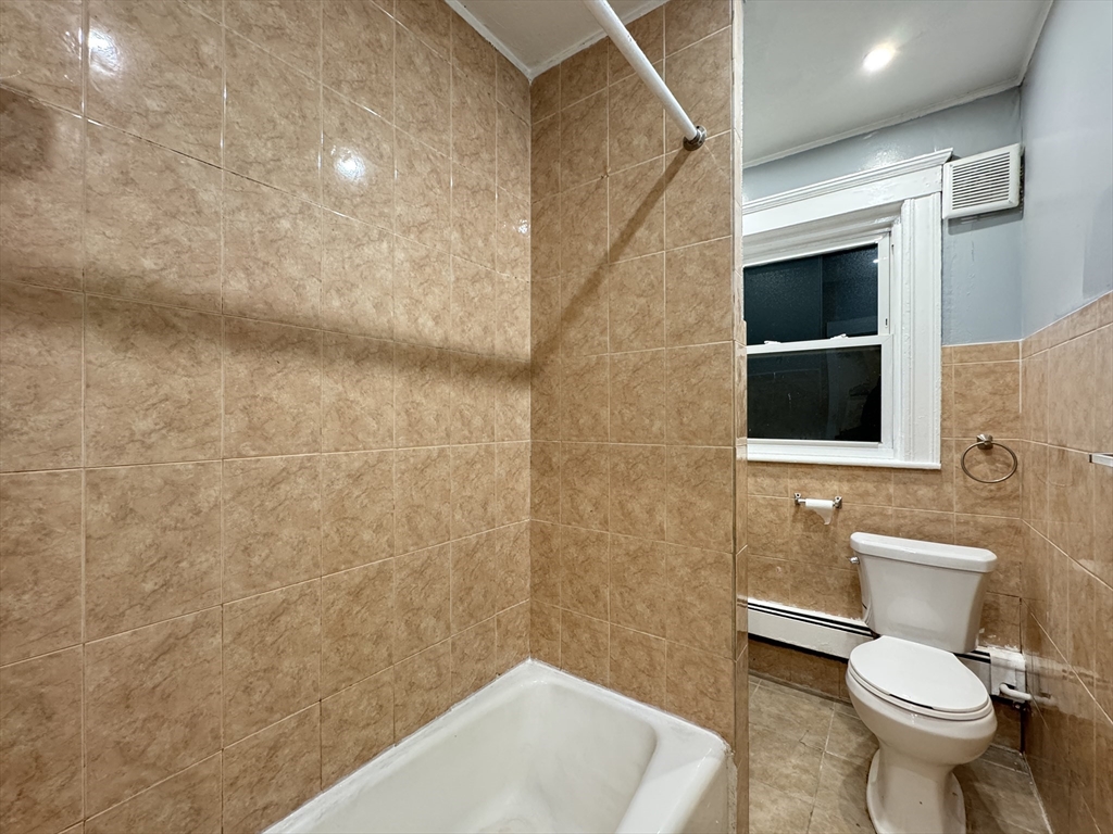 10 Faxon Road, Unit 1 Quincy, MA 02171 - Photo 8 of 11 a bathroom with a toilet and a sink