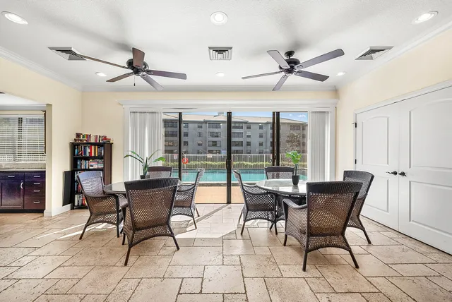 a work room with furniture and a floor to ceiling window