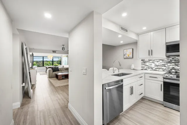 a kitchen with sink stove and cabinets