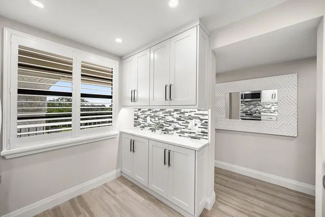 a kitchen with a stove and white cabinets
