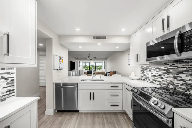 a kitchen with a sink stove and microwave