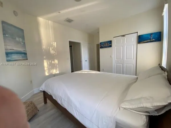 a bedroom with a bed and a large mirror