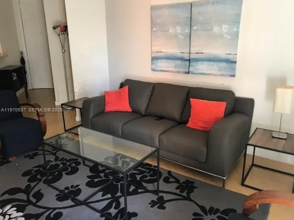 a living room with furniture and a window