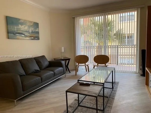 a living room with furniture and a large window