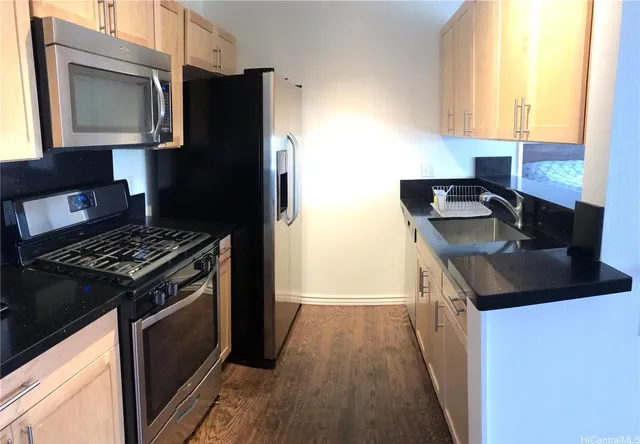 a kitchen with a sink stove and refrigerator