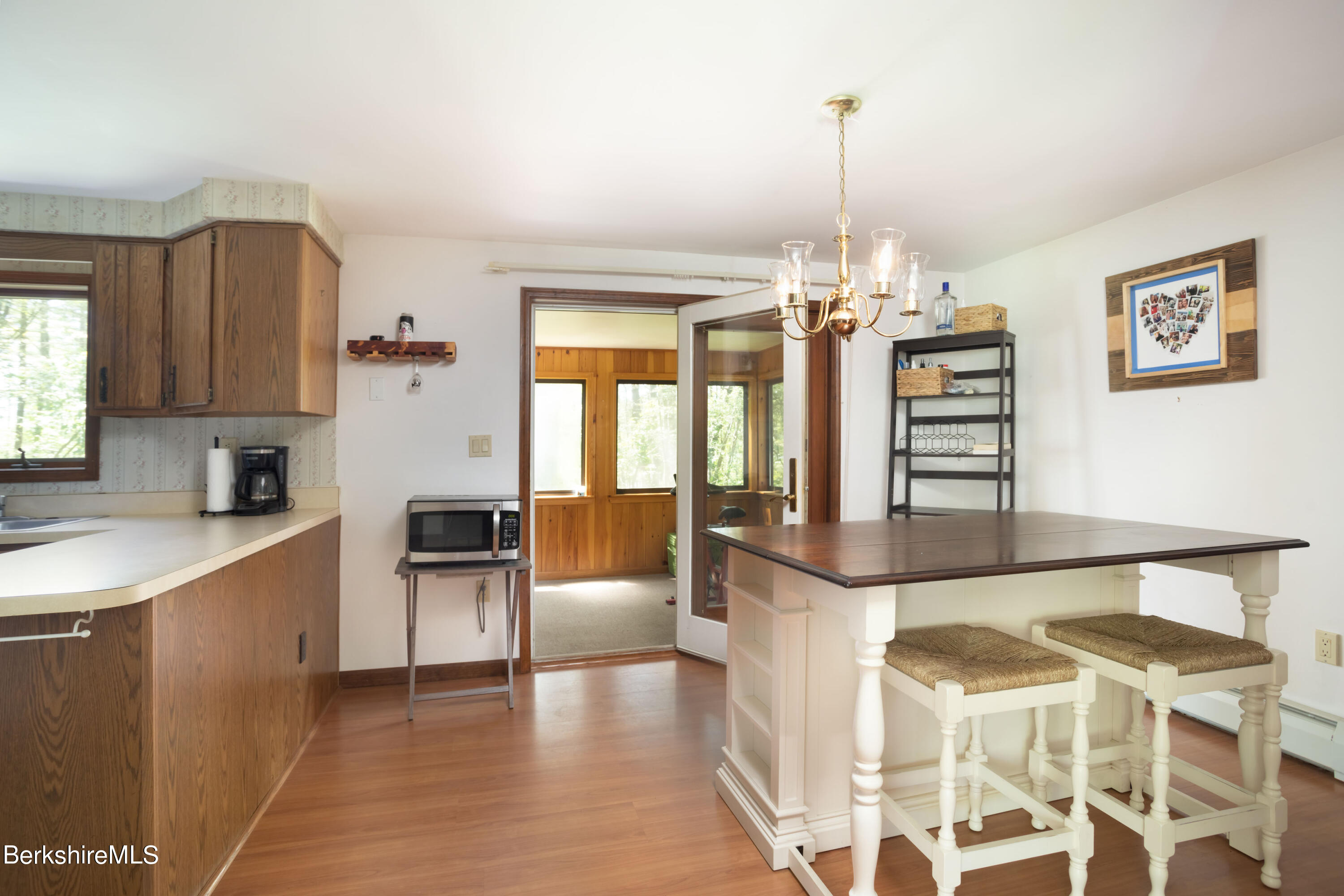140 Bunce Road North Sheffield, MA 01222 - Photo 7 of 17 a living room with furniture a flat screen tv and a chandelier