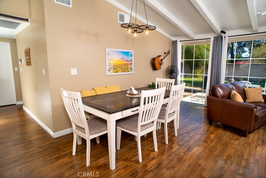 13232 Desmond Street Pacoima, CA 91331 - Photo 6 of 15 a dining room with furniture a chandelier and wooden floor