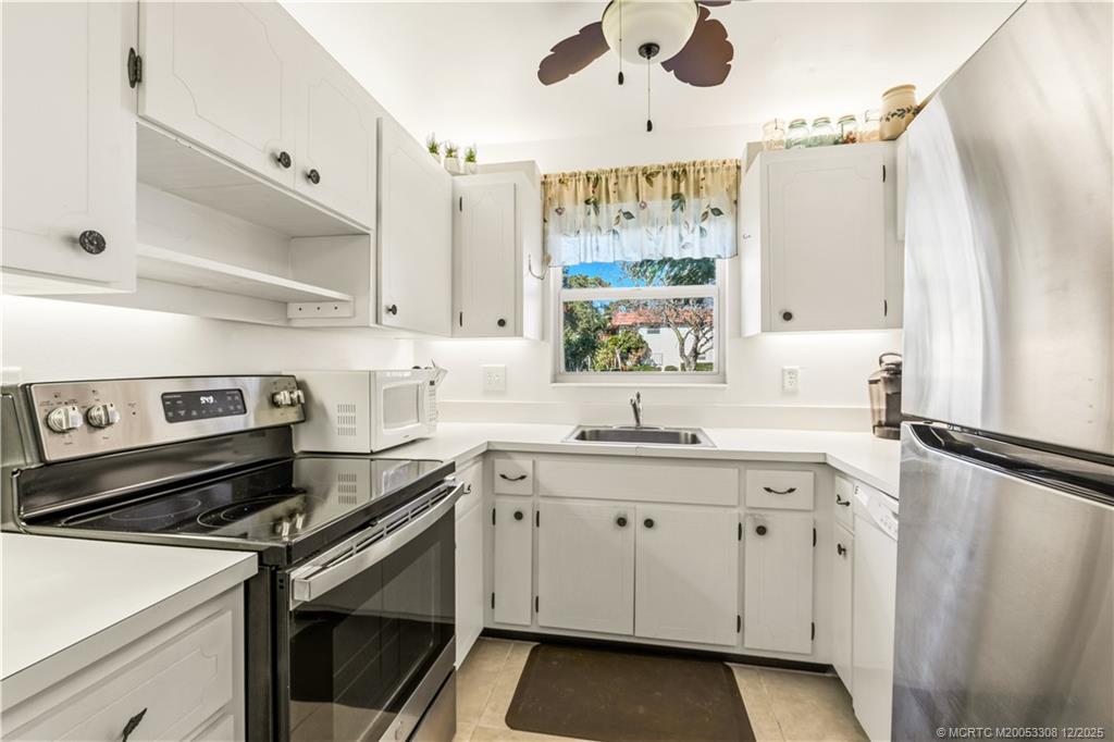2600 Southeast Ocean Boulevard, Unit F7 Stuart, FL 34996 - Photo 15 of 54 a kitchen with a sink appliances cabinets and a window
