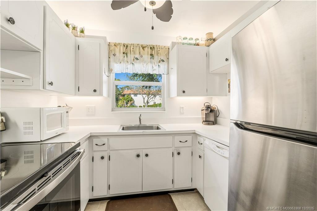 2600 Southeast Ocean Boulevard, Unit F7 Stuart, FL 34996 - Photo 16 of 54 a kitchen with white cabinets and sink