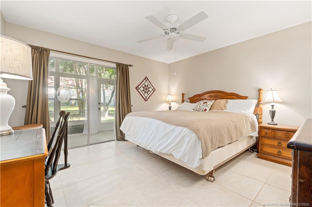 2600 Southeast Ocean Boulevard, Unit F7 Stuart, FL 34996 - Photo 19 of 54 a bedroom with a large bed and a large window