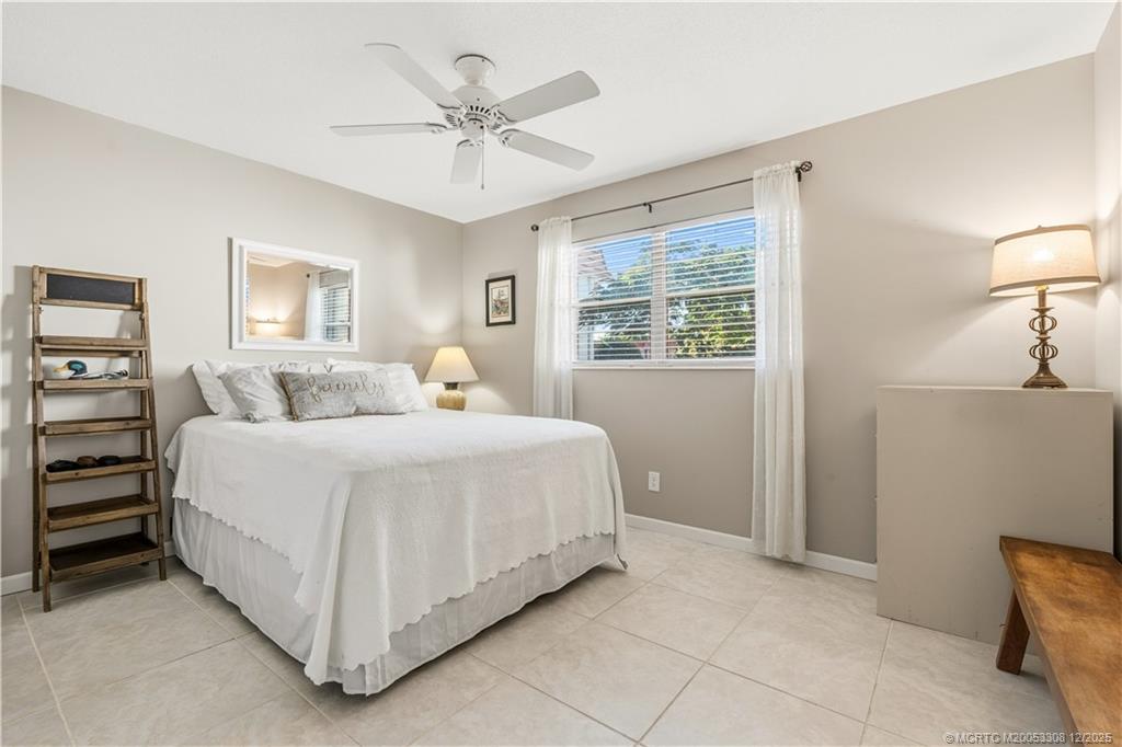 2600 Southeast Ocean Boulevard, Unit F7 Stuart, FL 34996 - Photo 25 of 54 a bedroom with a bed and a chandelier