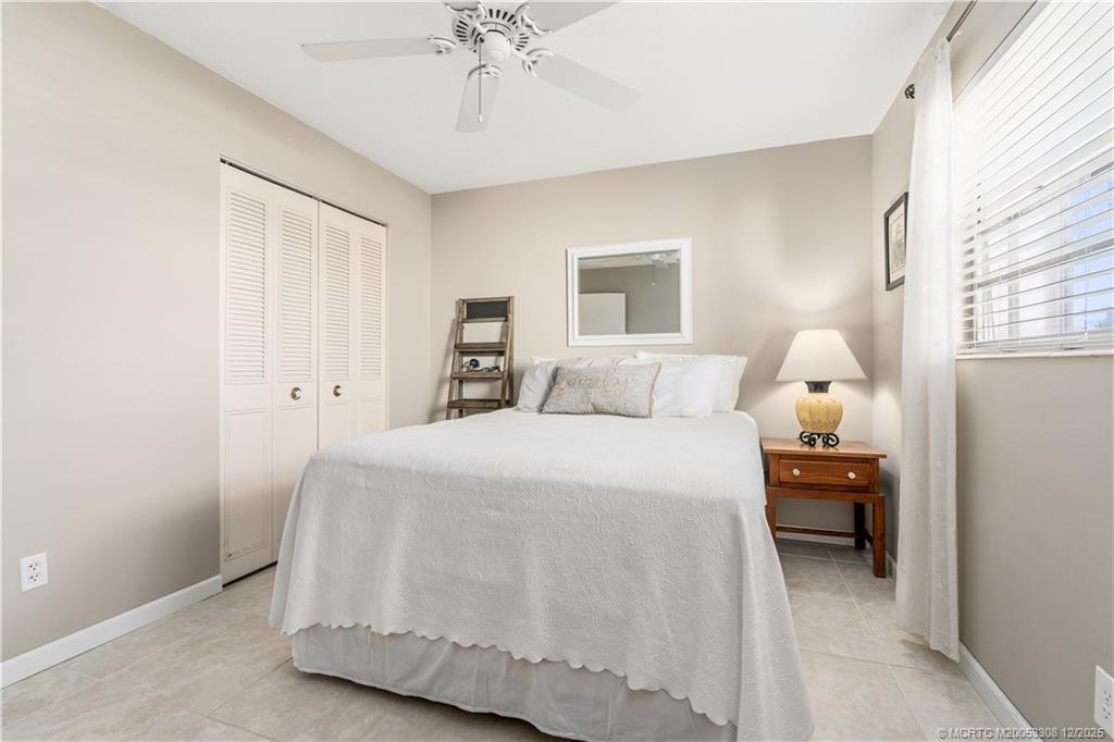 2600 Southeast Ocean Boulevard, Unit F7 Stuart, FL 34996 - Photo 26 of 54 a bedroom with a bed and a chandelier