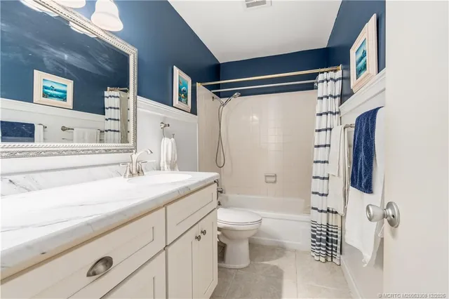 a bathroom with a sink toilet double vanity and shower