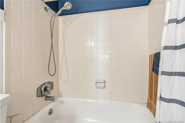 a bathroom with a tub and a shower