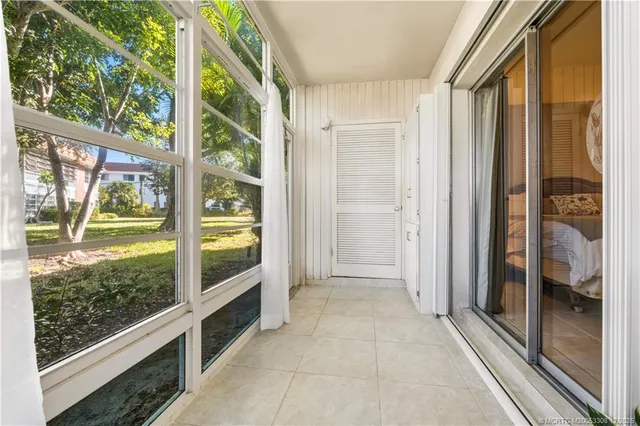 a view of a balcony with chair and front door