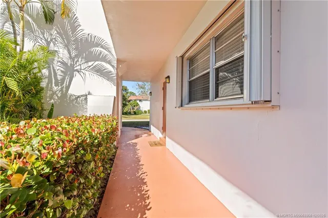 a view of a house with a large tree and a yard