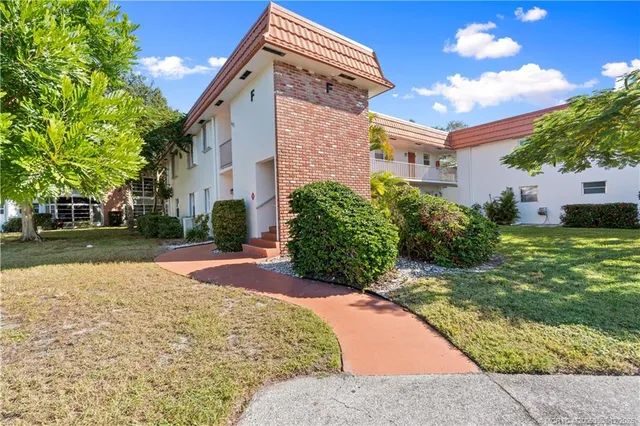 a view of swimming pool with a yard and lake view in back