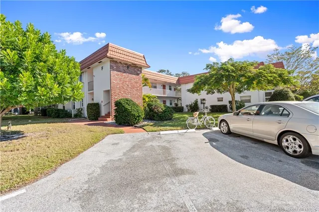 a view of a swimming pool with a yard and a fountain