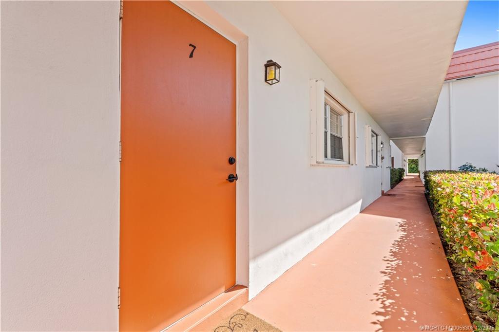 2600 Southeast Ocean Boulevard, Unit F7 Stuart, FL 34996 - Photo 5 of 54 a view of a hallway with wooden floor and staircase