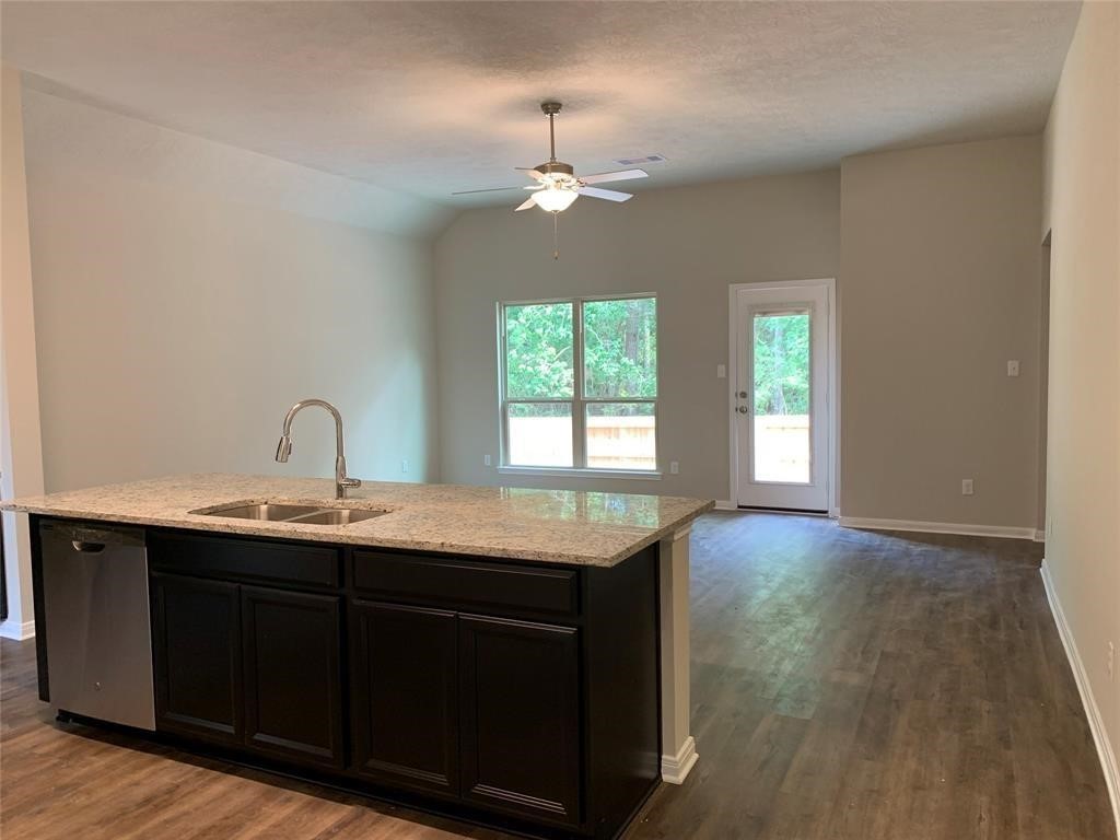 994 Arbor Crossing Conroe, TX 77303 - Photo 4 of 9 a kitchen with a sink and chandelier