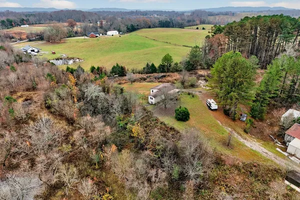 an aerial view of a houses with a lake view