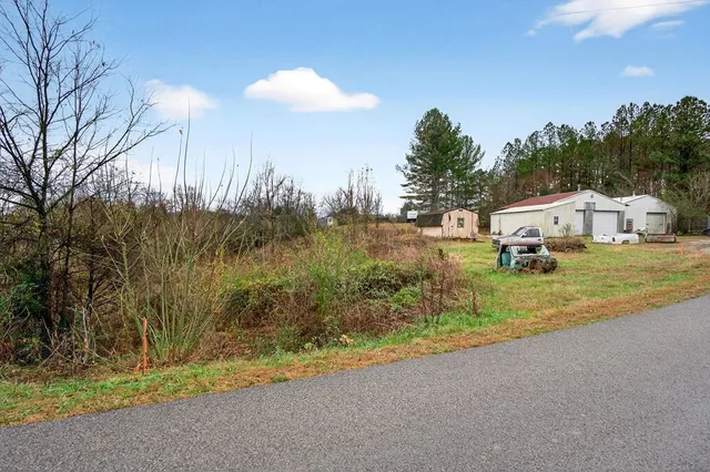 a view of a house with a yard and trees