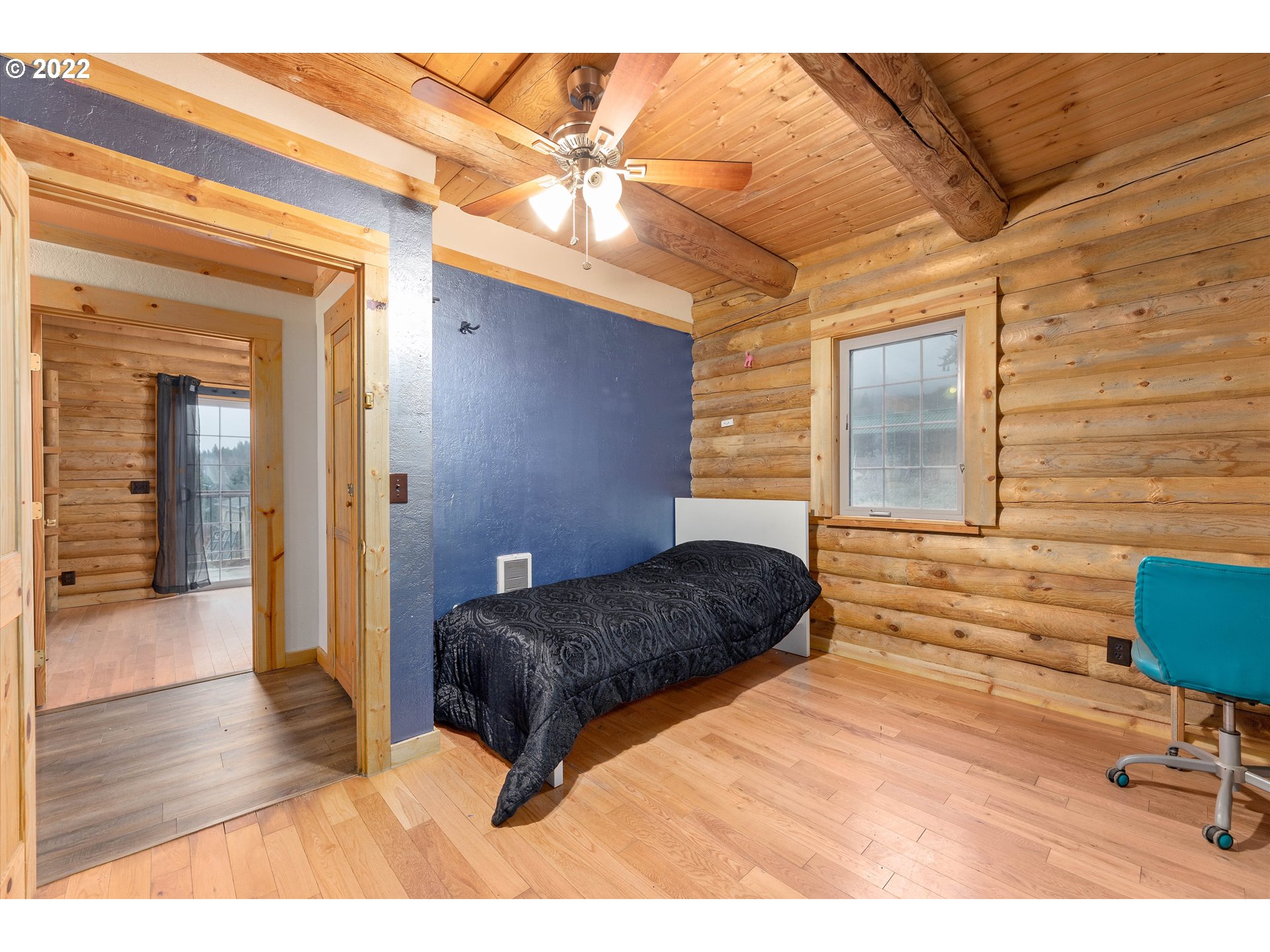 29134 Old Rainier Road Rainier, OR 97048 - Photo 8 of 30 a bedroom with a bed and a table with wooden floor