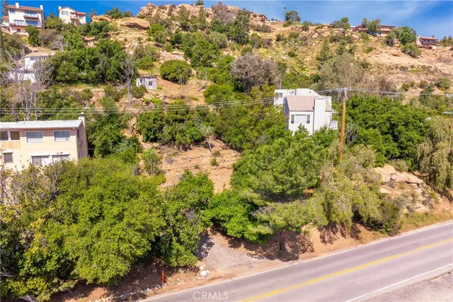 a aerial view of a house with a yard and lake view