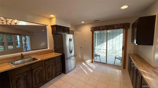 a spacious bathroom with a double vanity sink and a large mirror