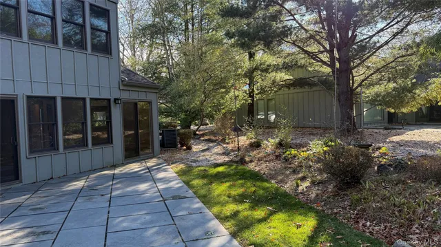 a view of a backyard with sitting area and garden
