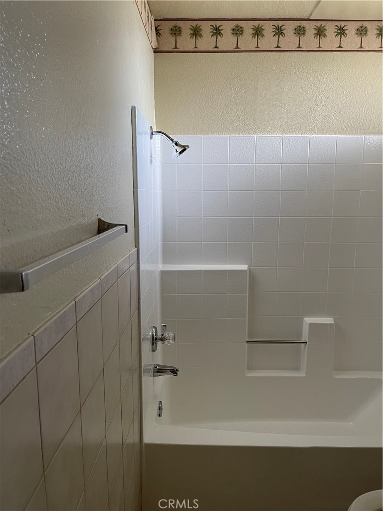 9279 Middlefield Drive Riverside, CA 92508 - Photo 18 of 26 a bathroom with a shower and a bath tub