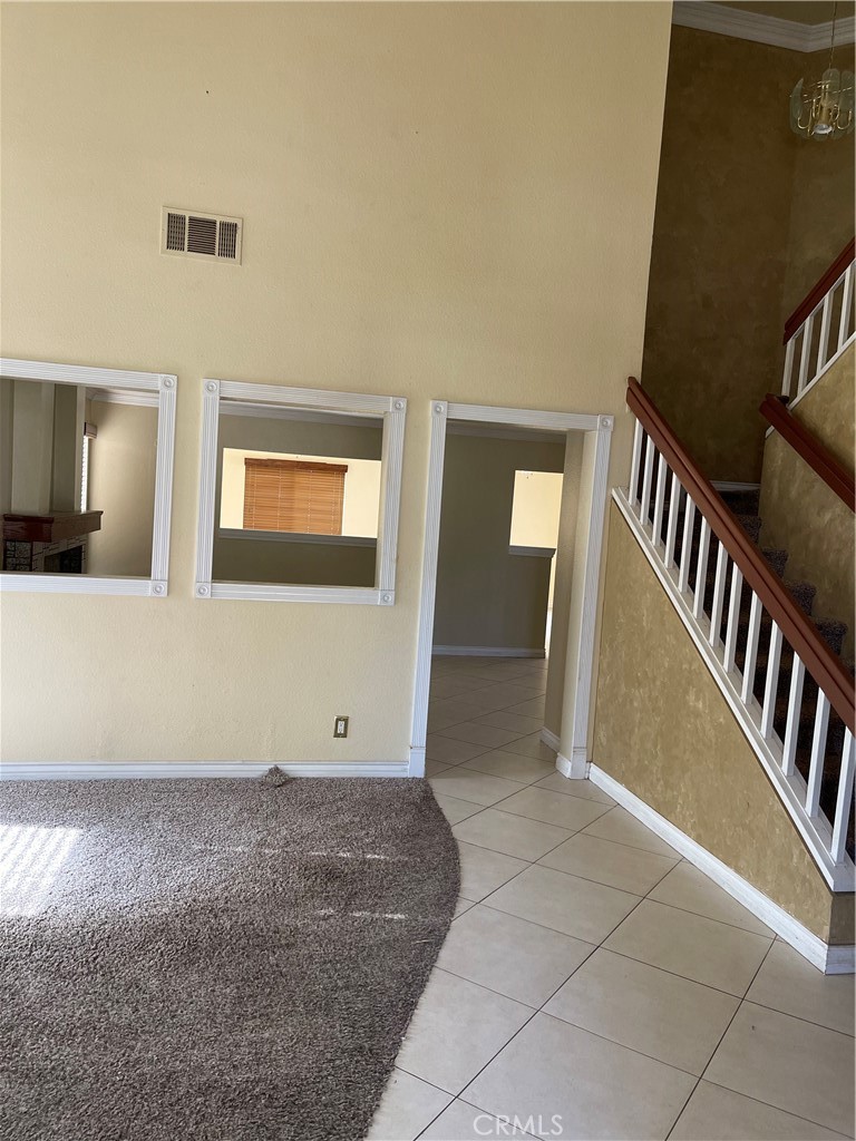 9279 Middlefield Drive Riverside, CA 92508 - Photo 4 of 26 a view of an empty room with stairs and a window