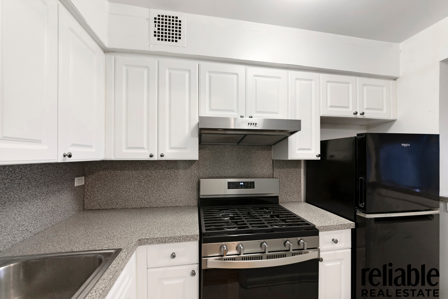 5235 Post Road, Unit 3H Bronx, NY 10471 - Photo 5 of 10 a kitchen with stainless steel appliances granite countertop a stove and a microwave