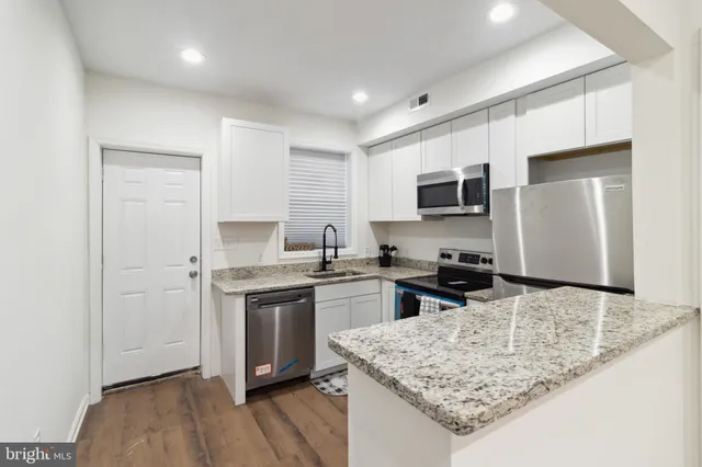 a kitchen with a sink stove and refrigerator