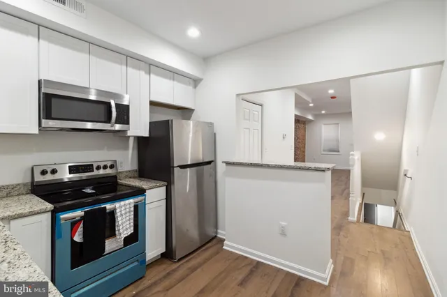 a kitchen with a refrigerator stove and microwave